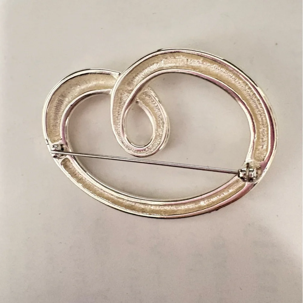 Vintage sign, Monet Silvertone heart shaped swirl Brooch